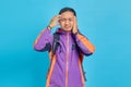 Portrait of stressed young Asian man touching his temples and having headache isolated on blue background Royalty Free Stock Photo