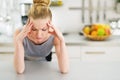 Portrait of stressed young housewife in kitchen Royalty Free Stock Photo