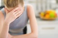 Portrait of stressed young housewife in kitchen