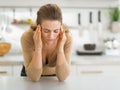 Portrait of stressed young housewife in kitchen Royalty Free Stock Photo