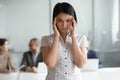 Portrait of stressed young korean employee suffering from headache. Royalty Free Stock Photo