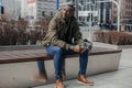 Portrait stressed young man hands on head with bad headache on city street. Negative human emotion facial expression Royalty Free Stock Photo