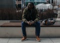 Portrait stressed young man hands on head with bad headache on city street. Negative human emotion facial expression Royalty Free Stock Photo