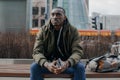 Portrait stressed young man hands on head with bad headache on city street. Negative human emotion facial expression Royalty Free Stock Photo