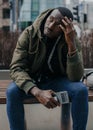 Portrait stressed young man hands on head with bad headache on city street. Negative human emotion facial expression Royalty Free Stock Photo