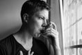 Portrait of stressed young man using asthma inhaler at home Royalty Free Stock Photo