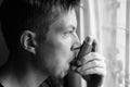 Portrait of stressed young man using asthma inhaler at home Royalty Free Stock Photo