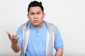 Portrait of stressed young overweight Asian man looking angry Royalty Free Stock Photo