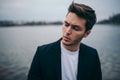 Portrait stressed young sad man wearing casual suit in the park outdoor background. Negative human emotion facial expression