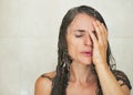 Portrait of stressed young woman in shower Royalty Free Stock Photo