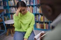 Stressed young woman hiding face in therapy session Royalty Free Stock Photo