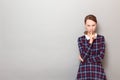 Portrait of strict girl showing silence gesture with finger over lips