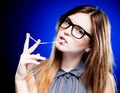 Portrait of strict young woman with nerd glasses and chewing gum Royalty Free Stock Photo