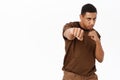 Portrait of strong african american man makes punch, standing in boxing pose, white background