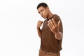 Portrait of strong african american man makes punch, standing in boxing pose, white background