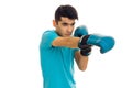 Portrait of strong brunette sports man practicing box in blue gloves isolated on white background Royalty Free Stock Photo