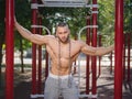 and muscular shirtless bodybuilder man showing off on a blurred background. Working out concept. Royalty Free Stock Photo