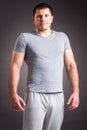 Portrait of strong healthy handsome Athletic Man Fitness Model posing near dark gray wall Royalty Free Stock Photo