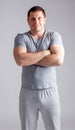 Portrait of strong healthy handsome Athletic Man Fitness Model posing near dark gray wall Royalty Free Stock Photo