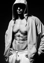 Portrait of strong healthy handsome Athletic Man Fitness Model posing near dark gray wall Royalty Free Stock Photo