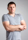 Portrait of strong healthy handsome Athletic Man Fitness Model posing near dark gray wall Royalty Free Stock Photo