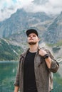 Portrait of strong hiker man in front of lake in mountains