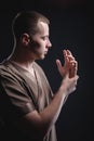 Portrait of a strong and large male masseur in special clothes with a finger at the temple reads your chin and knows all