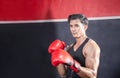 Portrait of Strong young athlete sportsman muay thai boxer fighting in gym, muscular handsome boxing man fighter with copy space Royalty Free Stock Photo