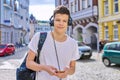 Portrait of student boy teenager with headphones smartphone backpack looking at camera Royalty Free Stock Photo