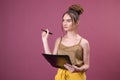 Portrait of student girl with pen and paper folder. Young pretty worker writing something in her papers Royalty Free Stock Photo