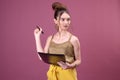 Portrait of student girl with pen and paper folder. Young pretty worker writing something in her papers Royalty Free Stock Photo