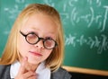 Portrait of student, nerd and child thinking by chalkboard for learning knowledge, education or study math. Serious face