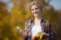 Portrait of student outsides, holding mobile phone in one hand Royalty Free Stock Photo