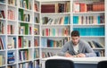 Portrait of student while reading book in school library