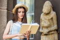 portrait of student in straw hat reading book Royalty Free Stock Photo