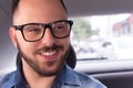 Portrait of Student traveler man with glasses looking away in auto car. Concept of aspirations, journey, motivation