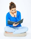 Portrait of student woman reading book sitting on a floor. Royalty Free Stock Photo