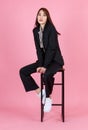 Asian beautiful urban trendy modern fashionable long hair female hipster teenager model in casual black suit with crop top shirt s Royalty Free Stock Photo