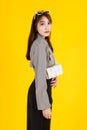 Asian trendy fashionable female hipster teen model in casual crop top street wears jacket sunglasses carrying leather handbag purs Royalty Free Stock Photo
