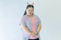 Portrait studio shot of Asian young cute chubby female down syndrome autistic model wear red dear antlers headband and casual Royalty Free Stock Photo