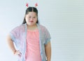 Portrait studio shot of Asian young cute chubby female down syndrome autistic model wear red dear antlers headband and casual Royalty Free Stock Photo