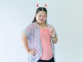 Portrait studio shot of Asian young cute chubby female down syndrome autistic model wear red dear antlers headband and casual Royalty Free Stock Photo