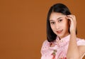 Portrait closeup studio shot millennial Asian female model in pink Chinese cheongsam qipao traditional peacock & flowers pattern