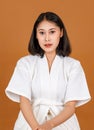 Portrait studio shot of millennial young Asian short black hair female model in white shower rope standing smiling look at camera Royalty Free Stock Photo