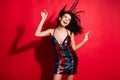 Portrait of stunning cheerful glad wavy-haired girl dancing disco bachelorette  on bright red color background Royalty Free Stock Photo