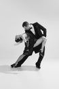Portrait of stunning couple wearing vintage style clothes and dancing tango. Concept of love and music. Monochrome Royalty Free Stock Photo