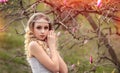 Portrait of stunning young beauty blonde with pink magnolia close-up, Beauty blonde with jewelry for hair. Crystal decoration Royalty Free Stock Photo