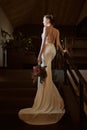 Portrait of Stunning young fashionable bride holding bouquet