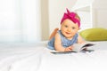 Portrait of stylish baby girl look through book Royalty Free Stock Photo