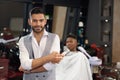 Portrait of stylish barber looking at camera in barber shop Royalty Free Stock Photo